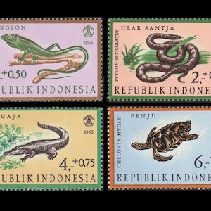 May include: Four Indonesian postage stamps featuring various animals. The top left stamp shows a green lizard with the text "BUNGLON" and "3,-+0.50 REPUBLIK INDONESIA". The top right stamp shows a brown snake with the text "ULAR SANTJA" and "2,+0,25 REPUBLIK INDONESIA". The bottom left stamp shows a crocodile with the text "BUAJA" and "4,+0.75 REPUBLIK INDONESIA". The bottom right stamp shows a turtle with the text "PENJU" and "6.-+1,- REPUBLIK INDONESIA".