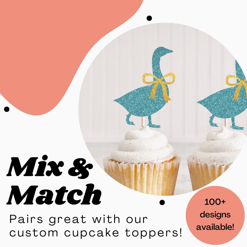 K&ouml;nnte beinhalten: Zwei Cupcakes mit blauen Glitzer-G&auml;nse-Cupcake-Toppern. Die Topper haben goldene Schleifen. Der Text "Mix & Match" ist in fetten schwarzen Buchstaben. Der Text "Pairs great with our custom cupcake toppers!" ist in schwarzen Buchstaben. Der Text "100+ designs available!" ist in wei&szlig;en Buchstaben auf einem rosa Kreis.
