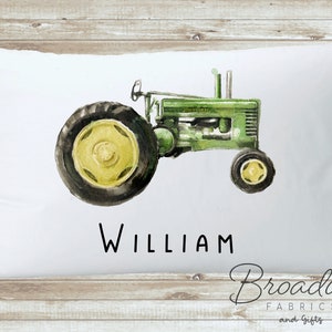May include: White pillowcase with a watercolor illustration of a green tractor and the name "William" printed below. The pillowcase is made by Broadway Fabrics and Gifts.