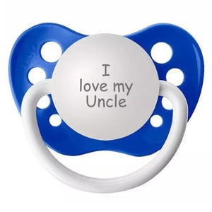 May include: A blue and white pacifier with the text "I love my Uncle" on the white part.