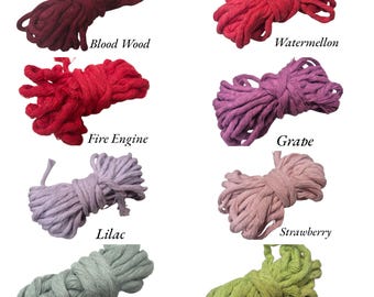 May include: A collection of eight bundles of colorful macrame cord in various shades. Colors include Blood Wood, Watermelon, Fire Engine, Grape, Lilac, Strawberry, Moss, and Avocado. Each bundle is labeled with its color name.