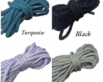 May include: Four bundles of rope in turquoise, black, lilac, and moss grey. Each bundle is tightly coiled, showcasing the texture and color variations. The colors are labeled with the corresponding names.