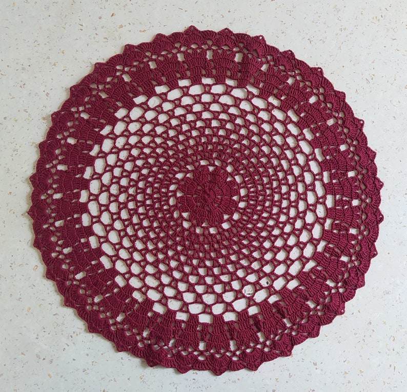 Thіs large crochet doily is made of cotton threads. Has a flat surface.  Suitable as a stand for vases, lamps, for dining, coffee and cosmetic tables. The doily perfectly complements the interior and creates comfort and style in your home.