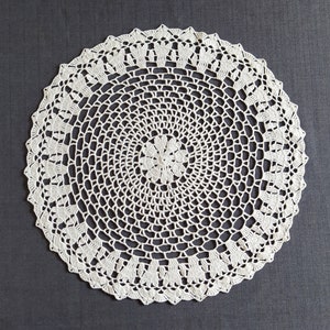 Thіs large crochet doily is made of cotton threads. Has a flat surface.  Suitable as a stand for vases, lamps, for dining, coffee and cosmetic tables. The doily perfectly complements the interior and creates comfort and style in your home.