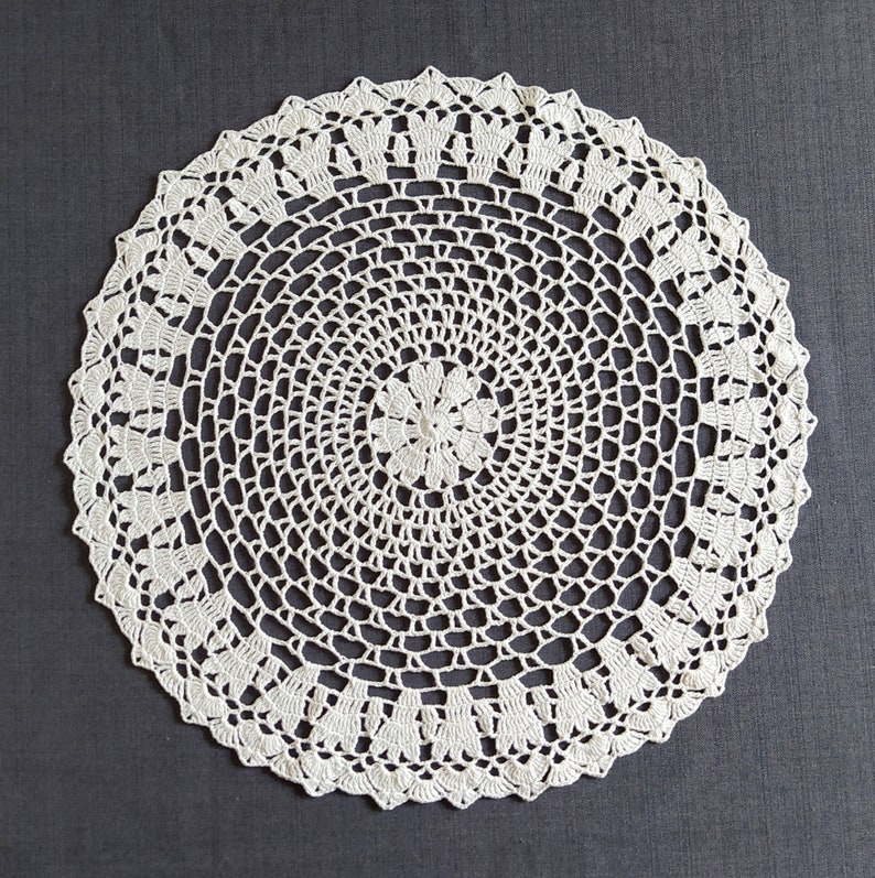 Thіs large crochet doily is made of cotton threads. Has a flat surface.  Suitable as a stand for vases, lamps, for dining, coffee and cosmetic tables. The doily perfectly complements the interior and creates comfort and style in your home.