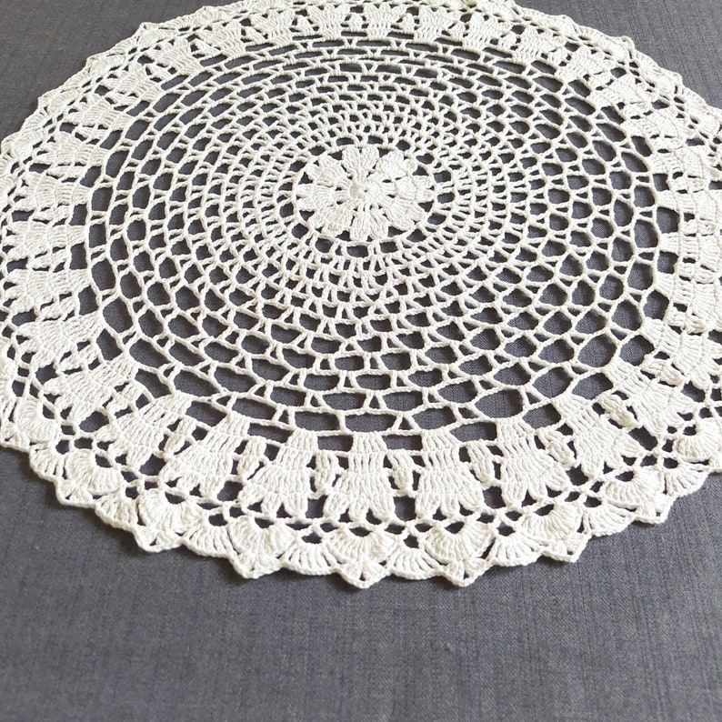 Thіs large crochet doily is made of cotton threads. Has a flat surface.  Suitable as a stand for vases, lamps, for dining, coffee and cosmetic tables. The doily perfectly complements the interior and creates comfort and style in your home.