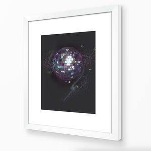 May include: A framed print featuring a disco ball illustration. The artwork depicts a spherical disco ball with a mosaic of colorful squares, set against a dark background with scattered stars and nebulous swirls. The frame is white.