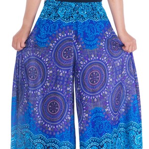 May include: Blue and purple printed palazzo pants with a floral design. The pants have a wide leg and a flowing silhouette.