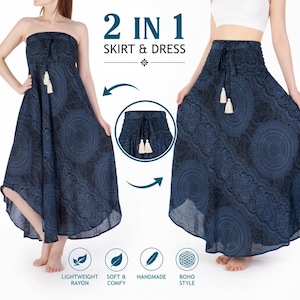 May include: A dark blue garment featuring a black mandala pattern that functions as both a strapless dress and a maxi skirt. It includes a smocked elastic waistband with a drawstring and two cream-colored tassels. Text reads 2 IN 1 SKIRT & DRESS.