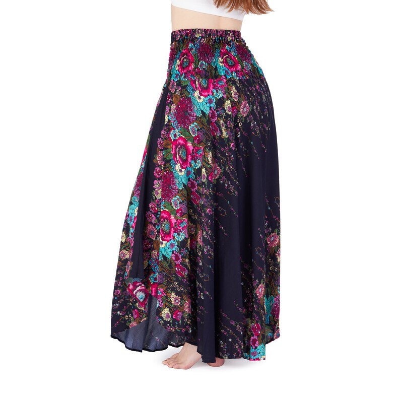 May include: A long, flowing skirt with a floral print in shades of pink, blue, and green on a black background. The skirt has an elastic waistband and a flowing, A-line silhouette.