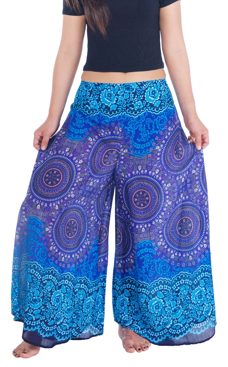 May include: Blue and purple printed palazzo pants with a floral pattern at the bottom hem.