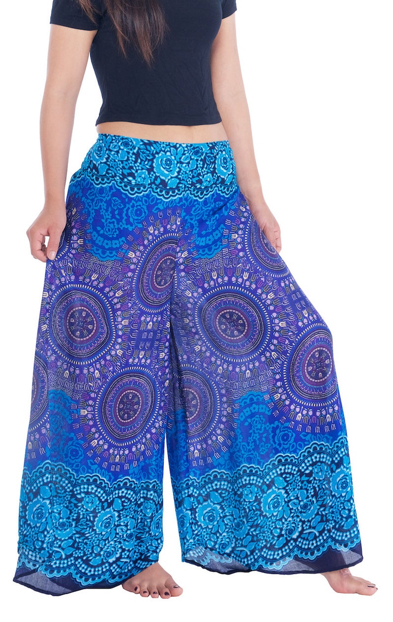 May include: Wide-leg pants with a blue and purple mandala print. The pants have a floral pattern at the bottom hem.