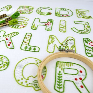 Good Will Monograms embroidery pattern for all 26 letters of the alphabet, each filled with Christmas scenes