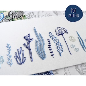 May include: A PDF pattern for embroidery featuring a row of 11 blue and white floral designs. The designs include a variety of flowers, leaves, and stems.