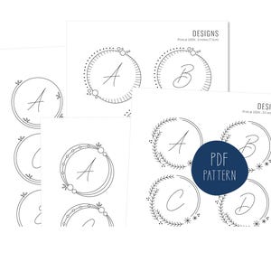 May include: A collection of white paper designs featuring circular frames with the letters A, B, C, and D. The designs include floral and dotted patterns. The text "DESIGNS" and "PDF PATTERN" are also visible.