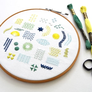 May include: A set of three ceramic mugs with a speckled, matte finish. The mugs are in shades of cream, light gray, and dark gray. Each mug has a simple, minimalist design, perfect for coffee or tea.