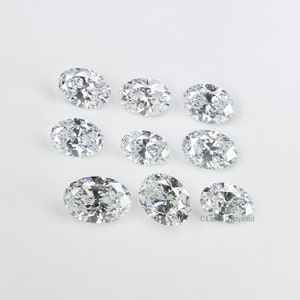 May include: Ten oval-shaped, clear, faceted gemstones on a white background.