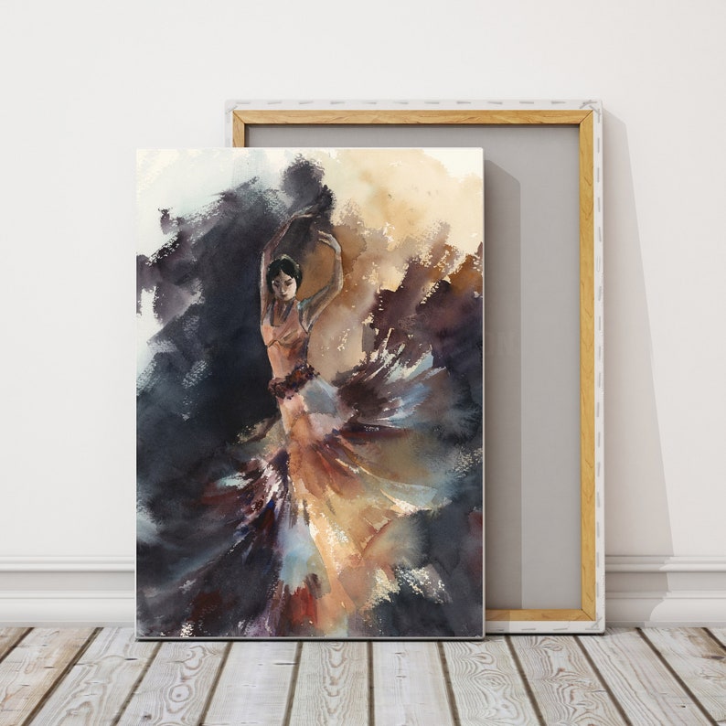 May include: Watercolor painting of a flamenco dancer in a flowing dress. The dancer is depicted with arms raised, surrounded by swirling brushstrokes of dark blue, brown, and gold. The canvas is displayed on a wooden floor.
