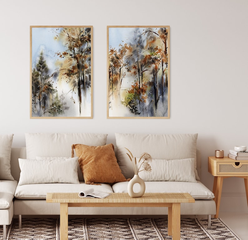 Pu&ograve; includere: Due dipinti ad acquerello incorniciati raffigurano una scena di foresta con alberi nei toni del marrone, verde e oro. L'opera d'arte ha un effetto morbido e sfocato, con uno sfondo azzurro e bianco. Le cornici sono di colore legno chiaro.