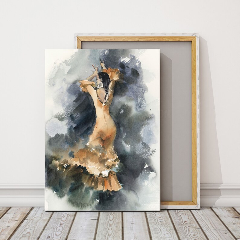 May include: Watercolor painting of a flamenco dancer in a flowing orange dress with ruffled accents. The dancer is posed mid-movement against a backdrop of dark blues and grays. The artwork is displayed on a canvas with a wooden frame.