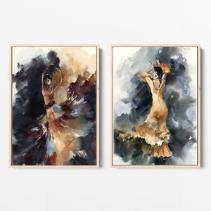 May include: Two framed watercolor paintings depict flamenco dancers in motion. The dancers are in flowing dresses of orange and brown hues, set against a backdrop of dark blues and browns. The artwork is framed in light wood.
