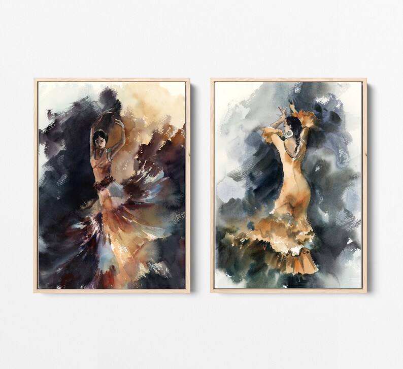 May include: Two framed watercolor paintings depict flamenco dancers in motion. The dancers are in flowing dresses of orange and brown hues, set against a backdrop of dark blues and browns. The artwork is framed in light wood.