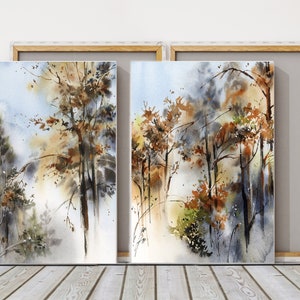Pu&ograve; includere: Due dipinti ad acquerello incorniciati di una scena di foresta. L'opera presenta alberi con foglie marroni e arancioni, su uno sfondo azzurro chiaro e bianco. I dipinti sono esposti su un pavimento in legno.