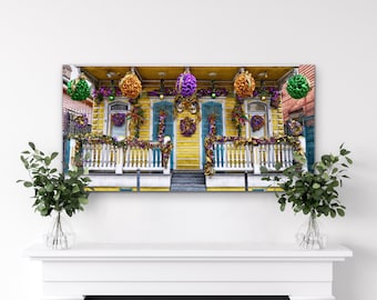 May include: A yellow house with a white picket fence and green, purple, and gold Mardi Gras decorations. The house has two doors with wreaths and a porch with a railing.