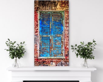 May include: A weathered blue wooden window shutter with faded paint and a brick wall background.