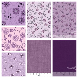 May include: A collection of various purple floral fabric swatches. The patterns include large and small flowers, vines, and solid textures. A ruler is included in some of the swatches, showing measurements in inches.