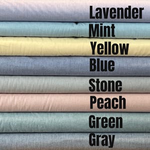 May include: A stack of eight fabric swatches in different colors, including lavender, mint, yellow, blue, stone, peach, green, and gray. The colors are labeled on the right side of the image.