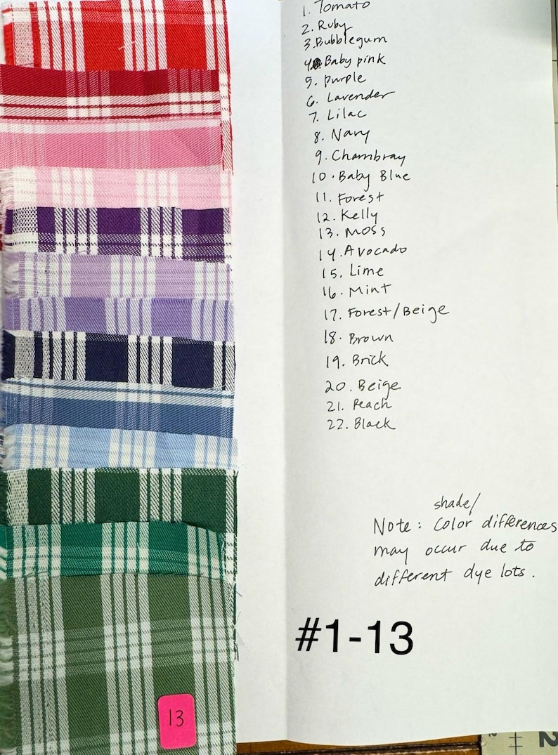 May include: A vertical column of thirteen fabric swatches featuring various plaid patterns in colors including red, pink, purple, blue, and green. A handwritten list labels the colors from 1 to 22, with a note about dye lot shade differences.