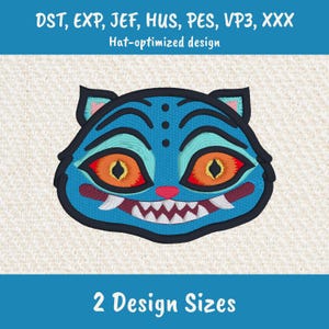 May include: Embroidered design of a blue cat face with orange eyes, red accents, and sharp white teeth. The design is labeled "Hat-optimized design" and includes the text "2 Design Sizes".