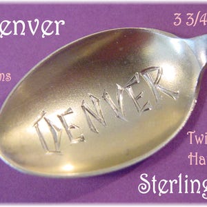 May include: A silver spoon with the word "Denver" engraved on the bowl. The spoon is 3 3/4 inches long and weighs 4 grams. It has a twisted handle and is made of sterling silver.