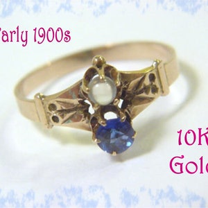 May include: A vintage 10K gold ring with a blue sapphire and a pearl. The ring is from the early 1900s.