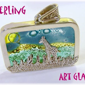May include: A rectangular sterling silver pendant with an art glass design. The pendant features a giraffe in a savanna scene with a yellow sun and blue sky. The words "STERLING" and "ART GLASS" are visible.