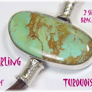 May include: Sterling silver bracelet featuring a large, oval turquoise stone. The turquoise is a light green color with brown matrix patterns. The bracelet is 1 1/4 inches long and has a hammered silver design. The text on the image says "2 SIDED BRACELET".