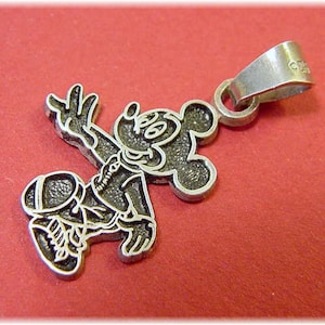May include: Silver charm pendant featuring a cartoon Mickey Mouse character in a running pose. The charm has a loop for attaching to a necklace or bracelet.