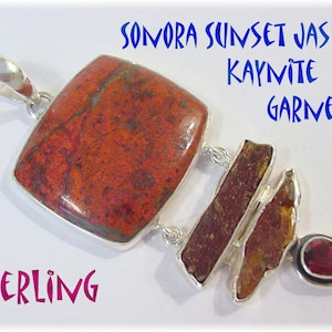 May include: Sterling silver pendant featuring a 3-inch Sonora Sunset Jasper stone. The pendant also includes Kaynite and a Garnet stone. The pendant has a rectangular shape with a silver bail.