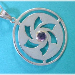 May include: A silver pendant necklace with a circular design featuring a cut-out swirl pattern and a purple gemstone in the center.