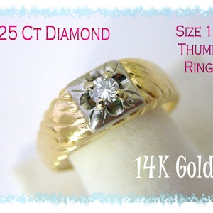 May include: A gold thumb ring with a single diamond set in a white gold setting. The ring is size 11 and is made of 14K gold. The text '.25 Ct Diamond' and 'Size 11 Thumb Ring' are visible in the image.
