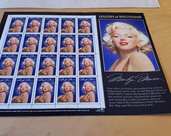 May include: A sheet of stamps featuring Marilyn Monroe, with a portrait of her on the right. The stamps have a blue background and a portrait of Marilyn Monroe. The sheet is labeled "Legends of Hollywood".