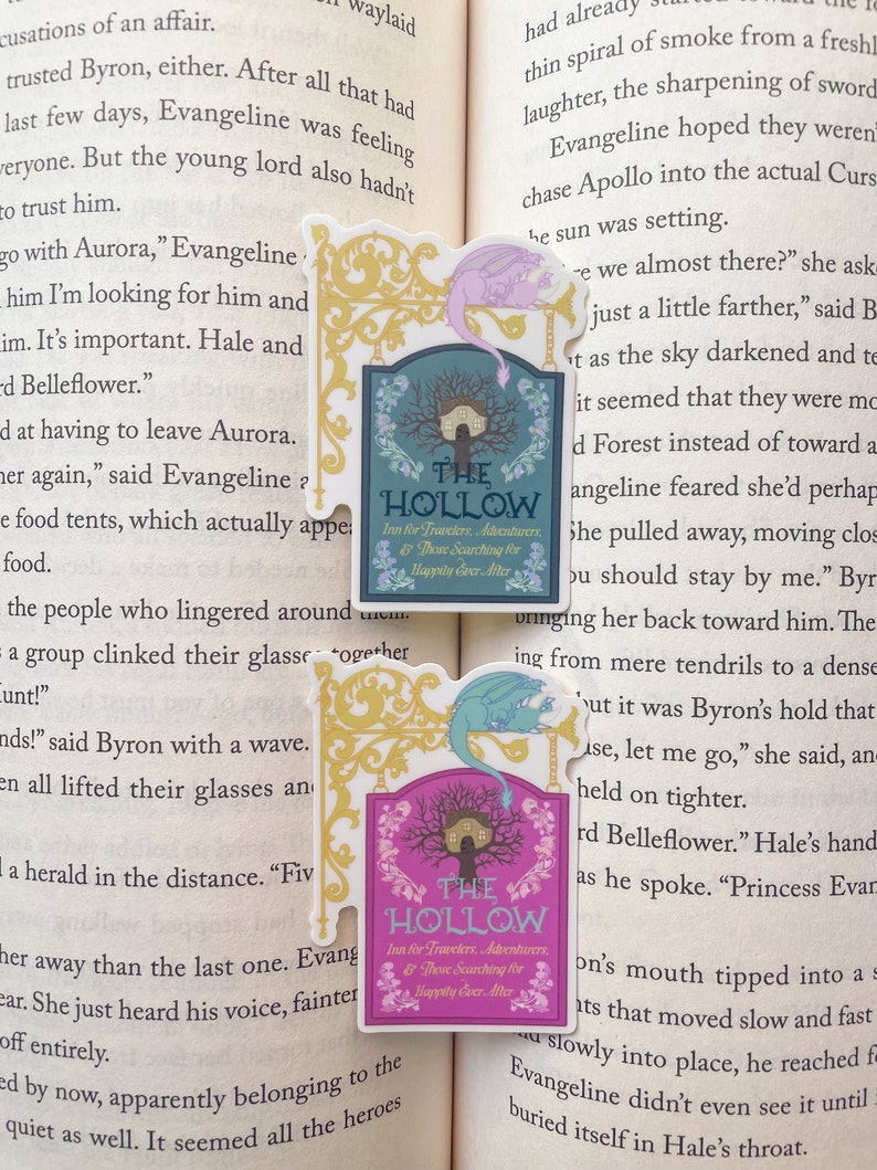 May include: A pink and gold sign with a whimsical font reads "The Hollow Inn for Travelers, Adventurers, & Those Searching for Happily Ever After". A light blue dragon with gold accents is perched on the sign.