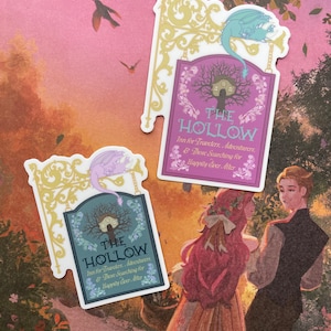 May include: Two stickers featuring a whimsical sign with a dragon and the text "The Hollow Inn for Travelers, Adventurers, & Those Searching for Happily Ever After". The sign is on a purple background with a gold frame. The stickers are on a pink and orange background with a couple standing in the foreground.