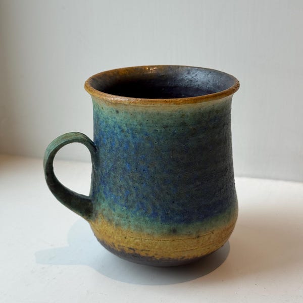 A very rare and collectable handmade art ceramic mug with a distinctive blue-green and brown glaze by Francesca Mascitti Lindh