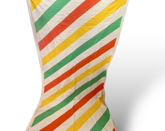 May include: A white fabric with diagonal stripes in red, yellow, and green.