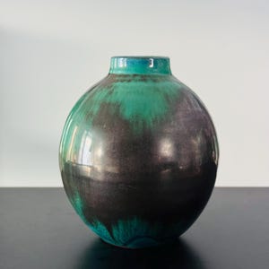 A beautiful Earthenware vase with multiple alternative firing technique. Signed by artist