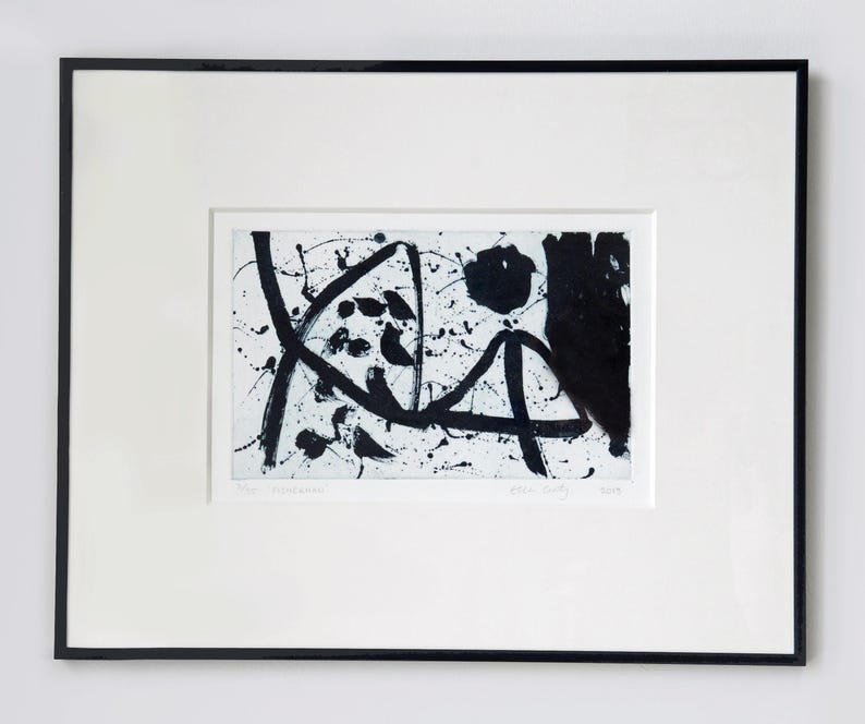 May include: Black and white abstract art print with a white background and black ink splatters and lines. The print is framed in a black frame.