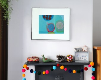 May include: A framed abstract painting with blue, green, red, and white colors hangs on a white wall above a fireplace mantel. The mantel is decorated with a colorful pom-pom garland, a small green bird figurine, a pine cone, a colorful ornament, and a white sign that says "Happy".