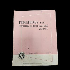 May include: A vintage book cover with the title "PROCEEDINGS OF THE INSTITUTION OF RADIO ENGINEERS AUSTRALIA" in black text. The cover is primarily pink with a white and gray band at the bottom. The volume number and date are also visible.